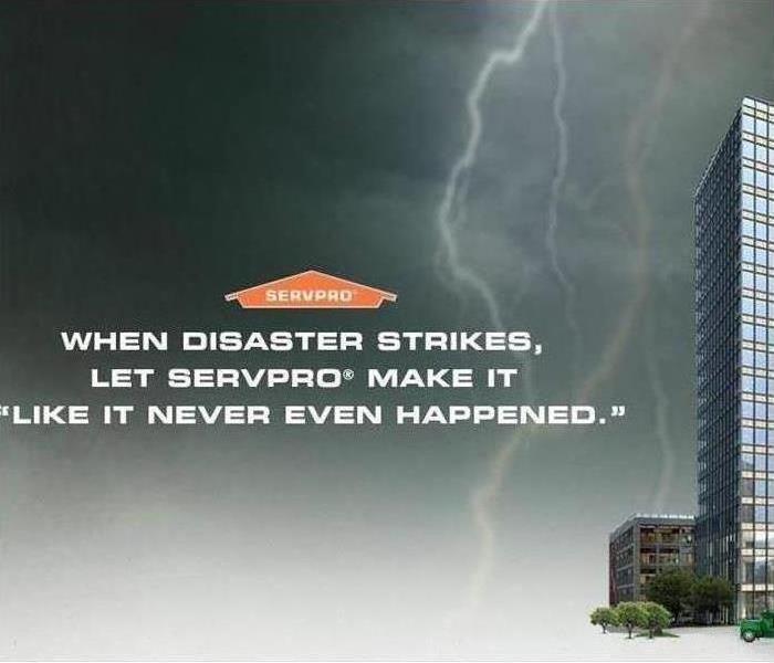 black, grey, and white background with a lightning bolt and tall skyscraper to the right. SERVPRO house with words under it.